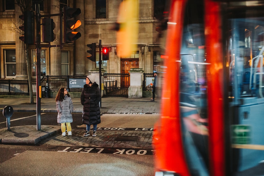 a person and a child walking on a sidewalk