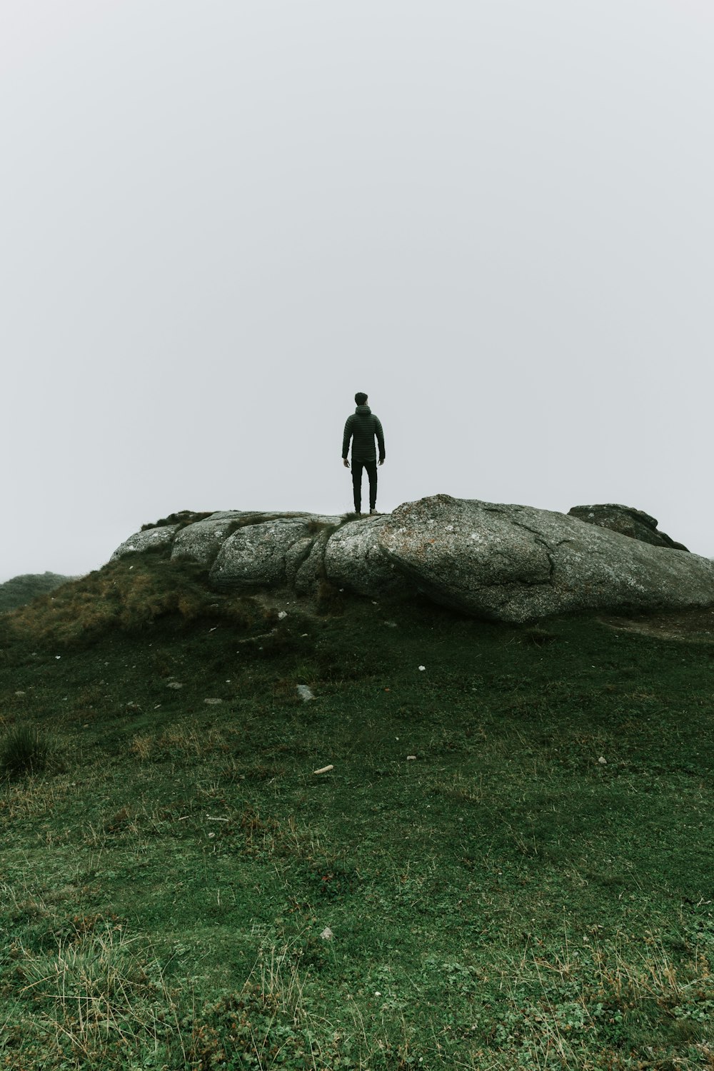 a person standing on a rock