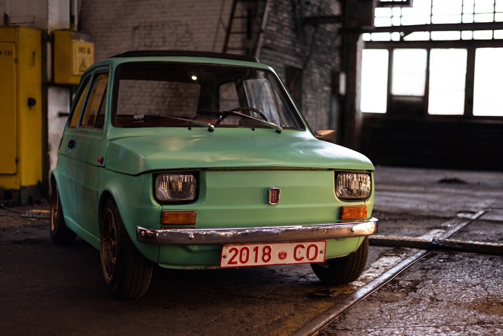 a green car parked in a garage