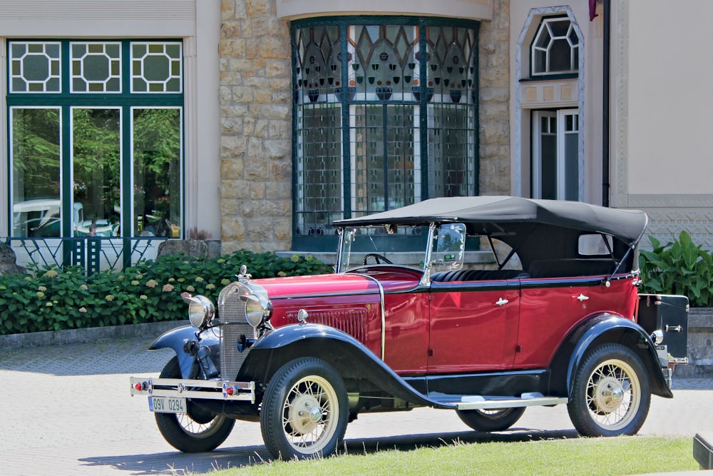 a red car parked in front of a building