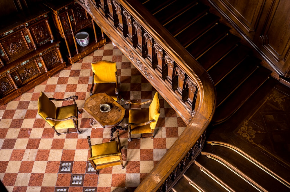 a staircase with a rug and chairs