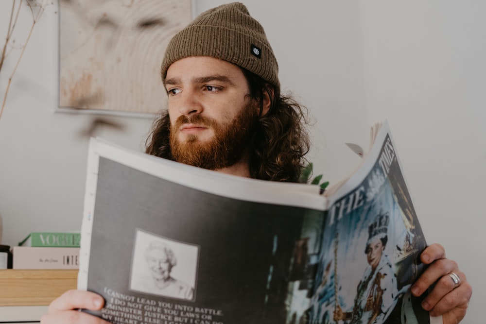 a man with a beard reading a book