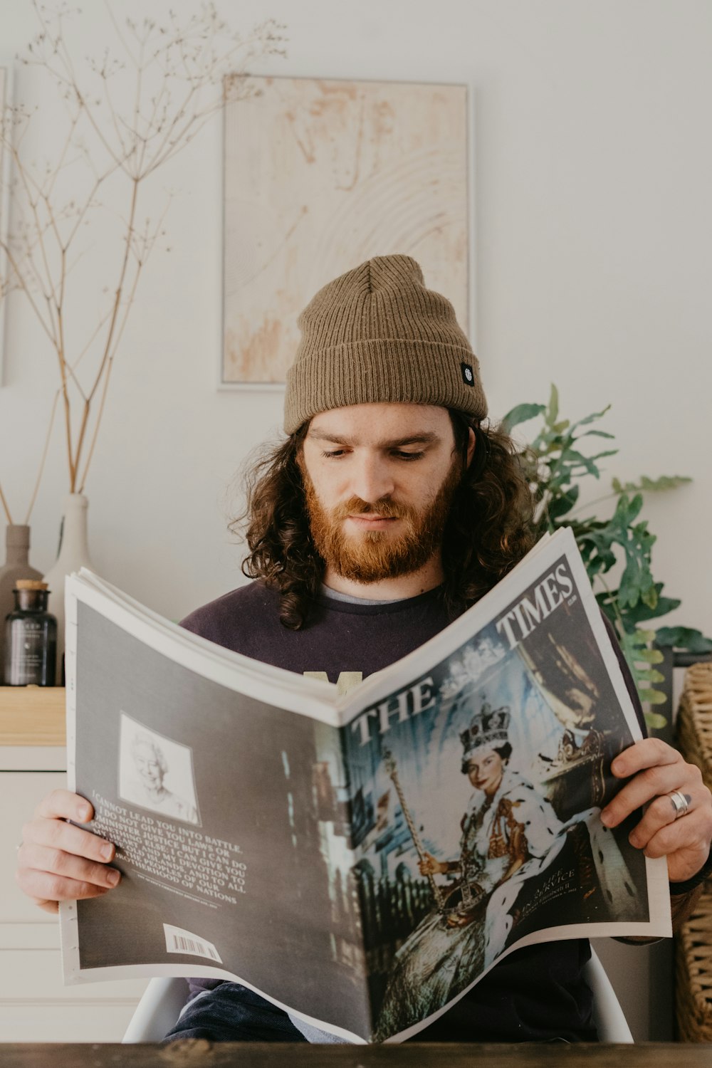 a person wearing a hat and holding a book