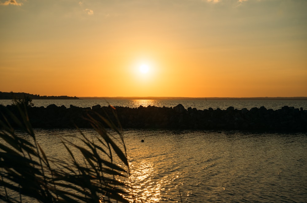 a sunset over a body of water