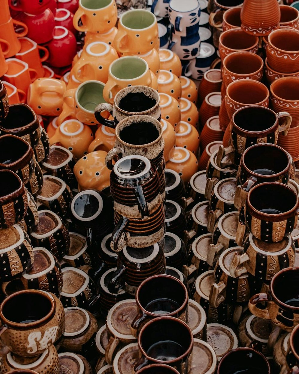 a large group of vases are lined up