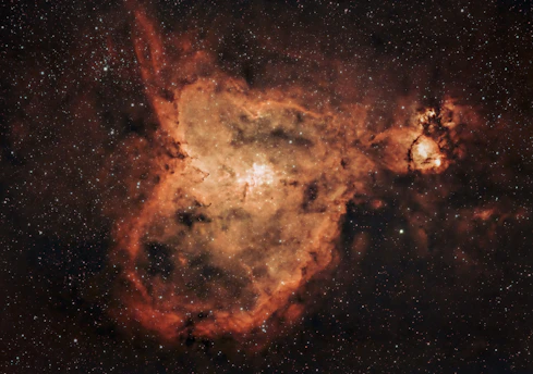 A glowing, nascent star bursting to life within a swirling cosmic nebula, surrounded by shimmering clouds of gas and dust.