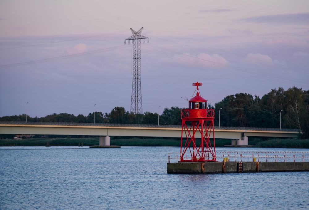 a red light house on a dock