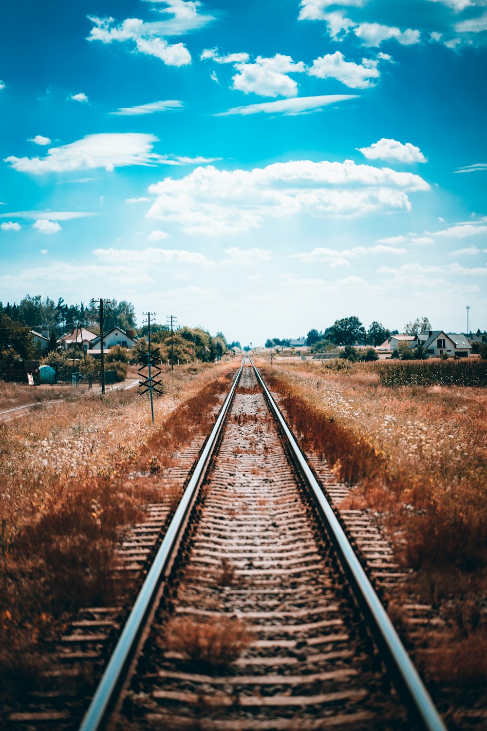 train tracks with houses in the background