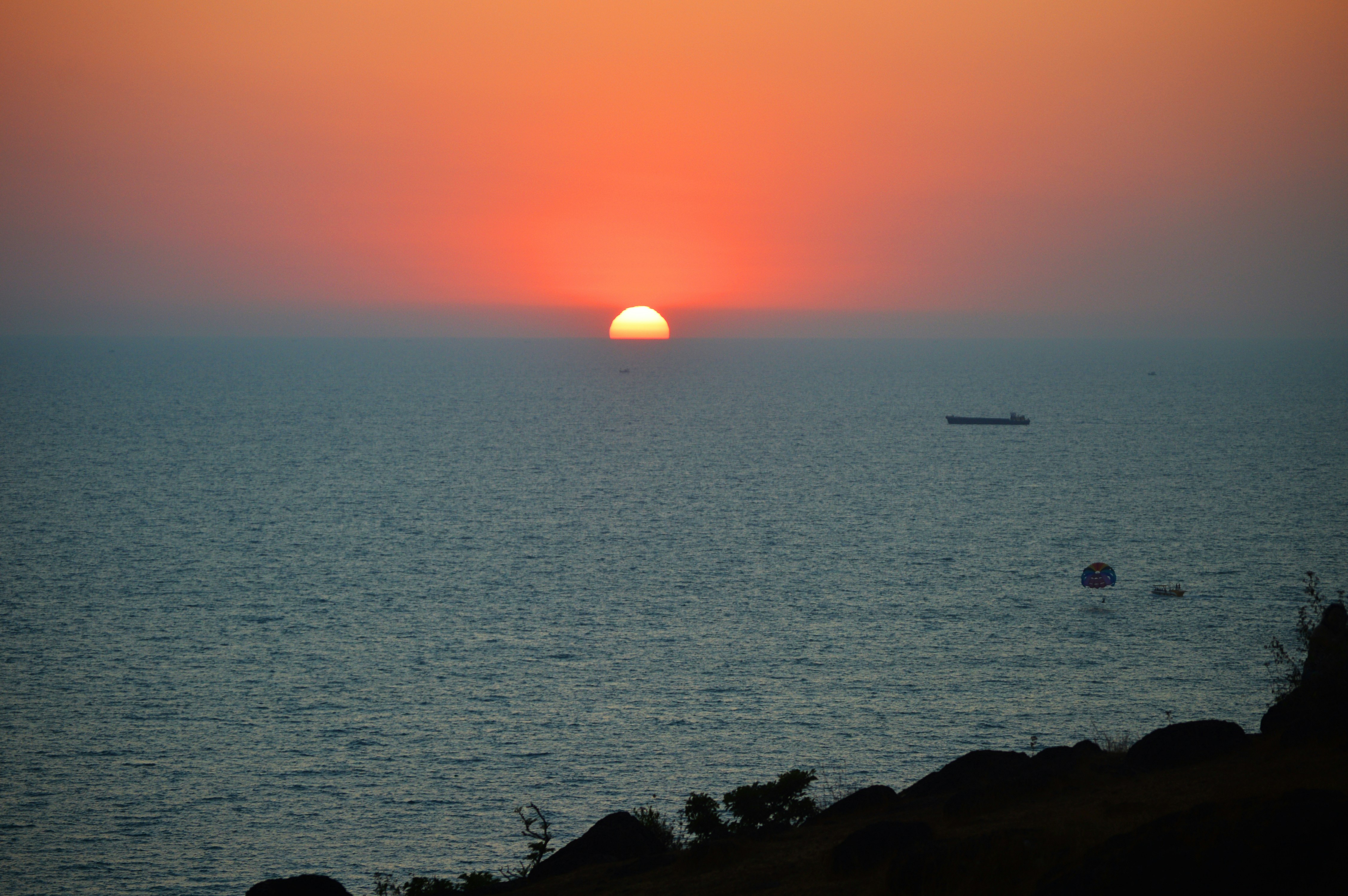 a sunset over a body of water, 