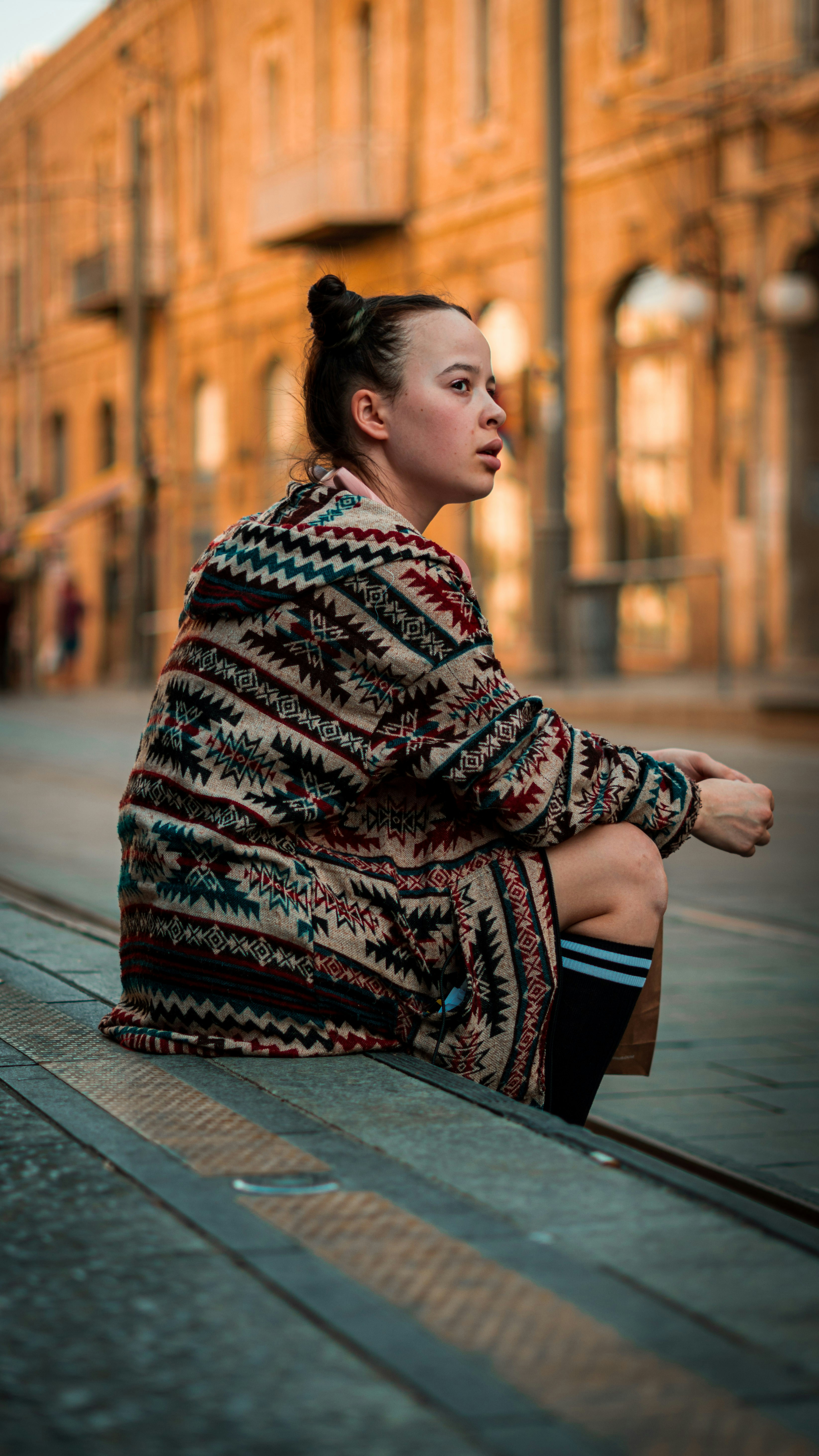 a person sitting on a brick surface