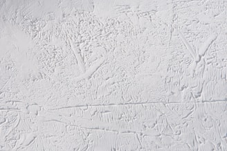 Abstract textured surface with intricate patterns and a rough, uneven appearance.