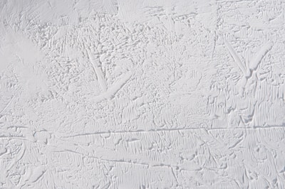 Abstract textured surface with intricate patterns and a rough, uneven appearance.