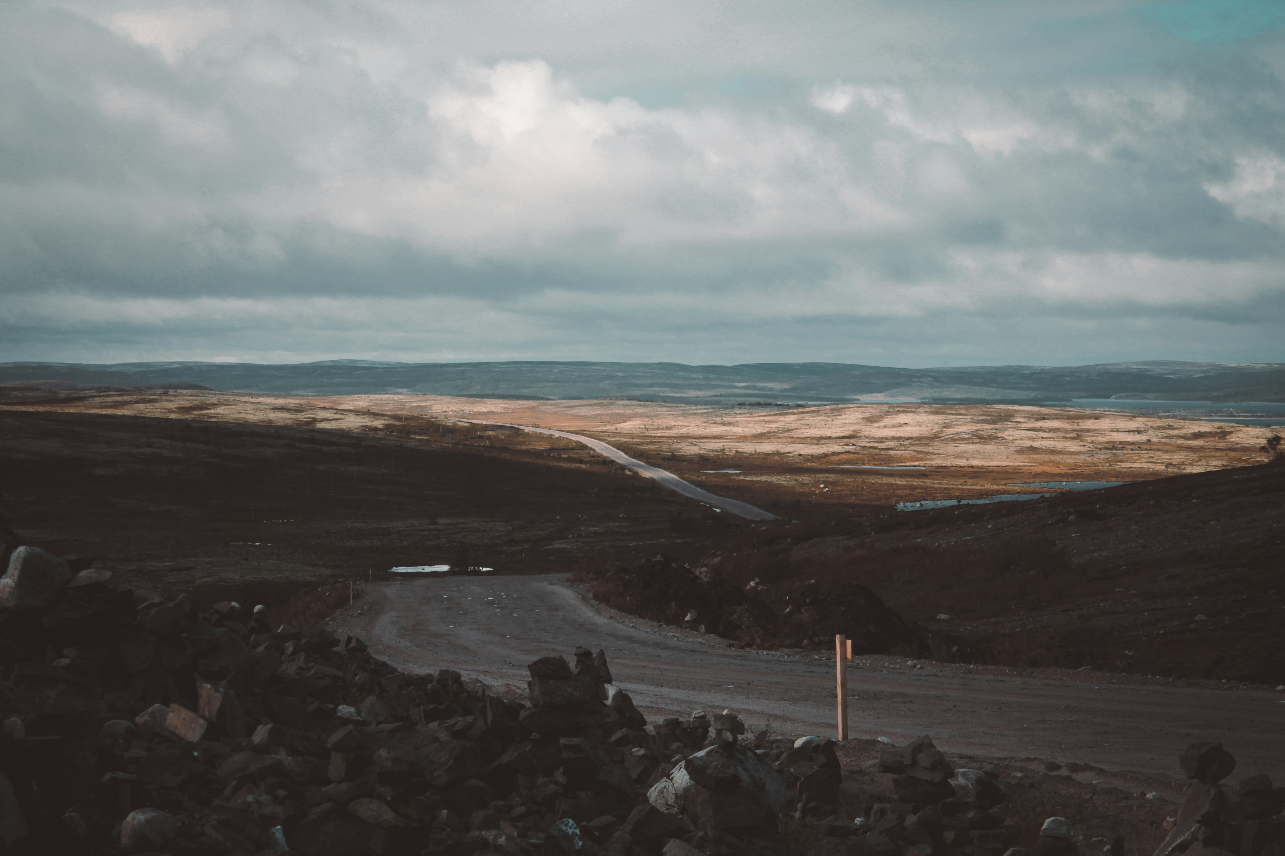 a rocky beach with a body of water in the background