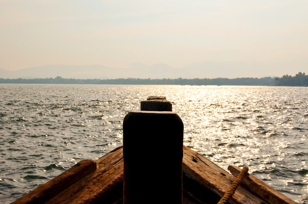 a wood dock with a body of water in the background