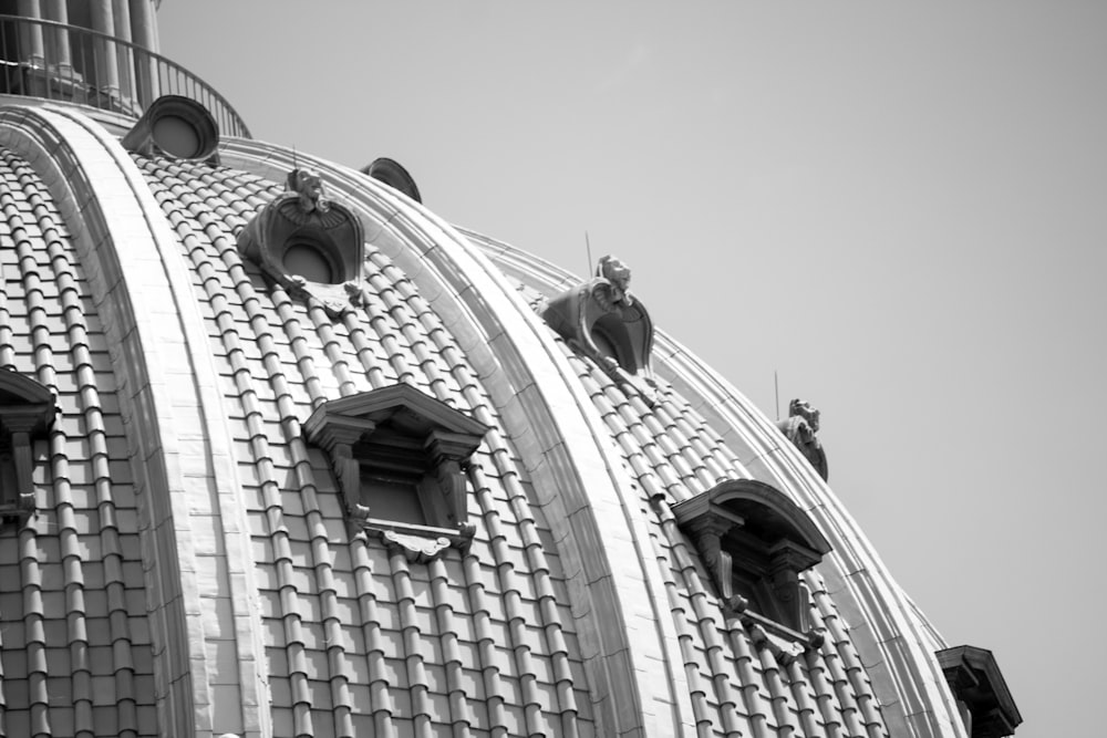 a stone building with statues on the roof