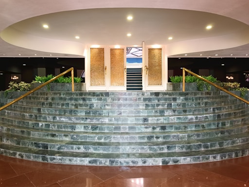 Elegant marble and granite showroom entrance with warm lighting and gold accents.