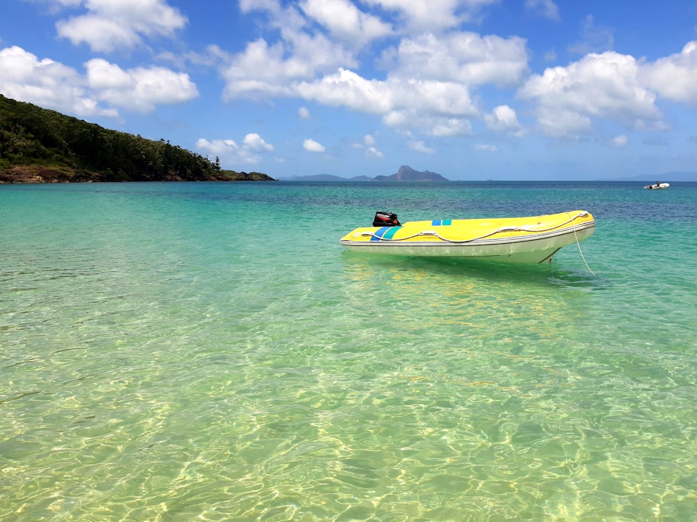 a person in a yellow boat in the water