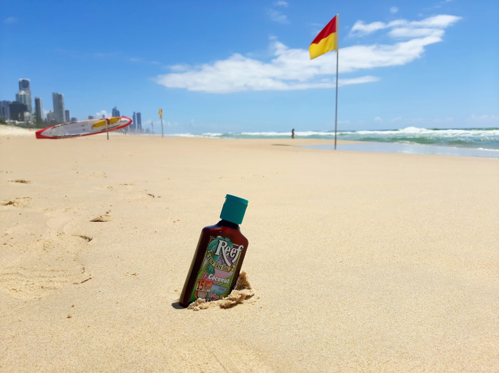 a bottle of beer on a beach