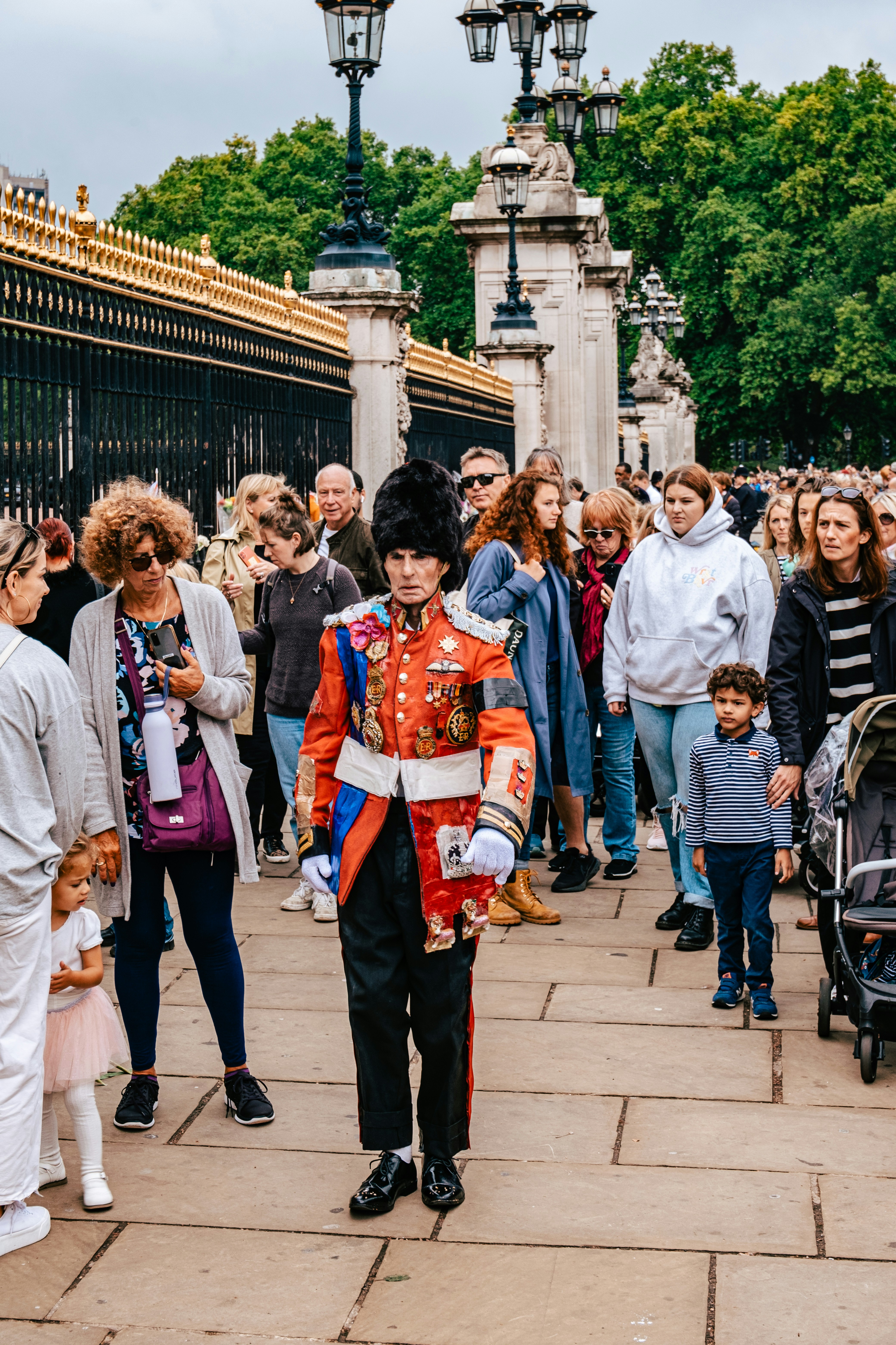 a person in a garment walking in front of a crowd of people