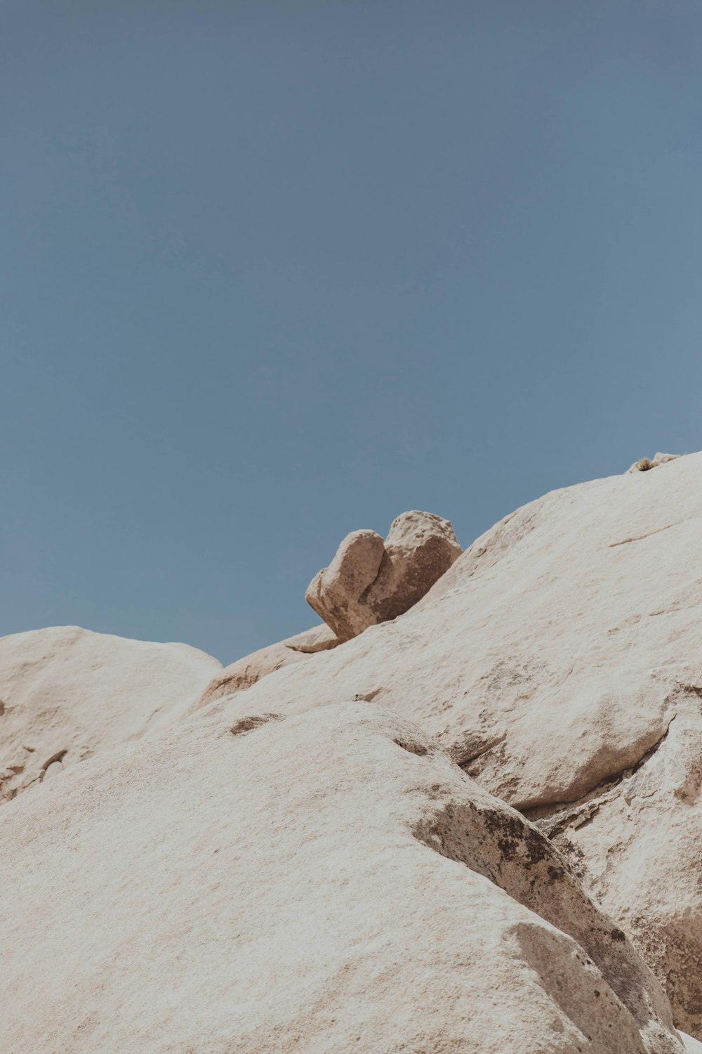 a rocky mountain with a blue sky