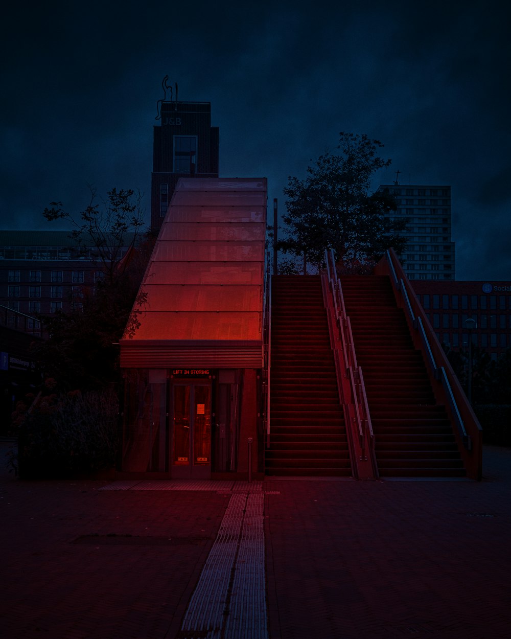 a red building with stairs leading up to it at night