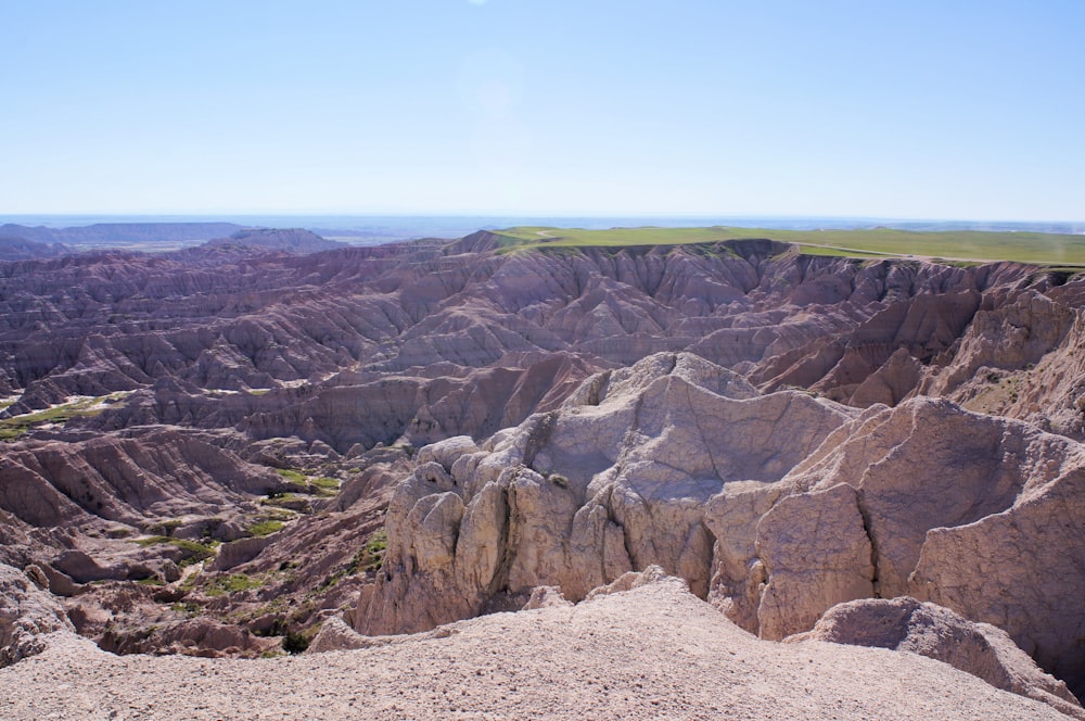 a rocky landscape with a body of water in the background