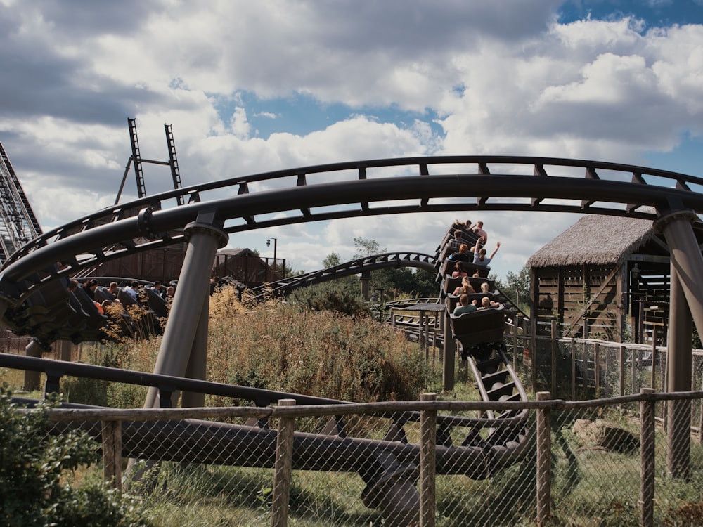 a roller coaster with a fence around it