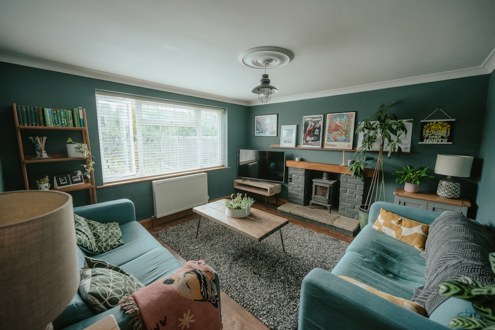 a living room with green furniture