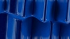 High-quality image of glossy PLA resin granules with a navy blue tint