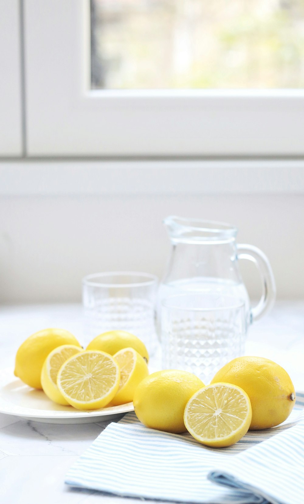 lemons and a glass of water on a table