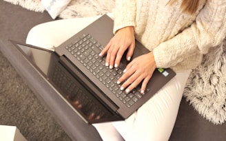 a person typing on a laptop