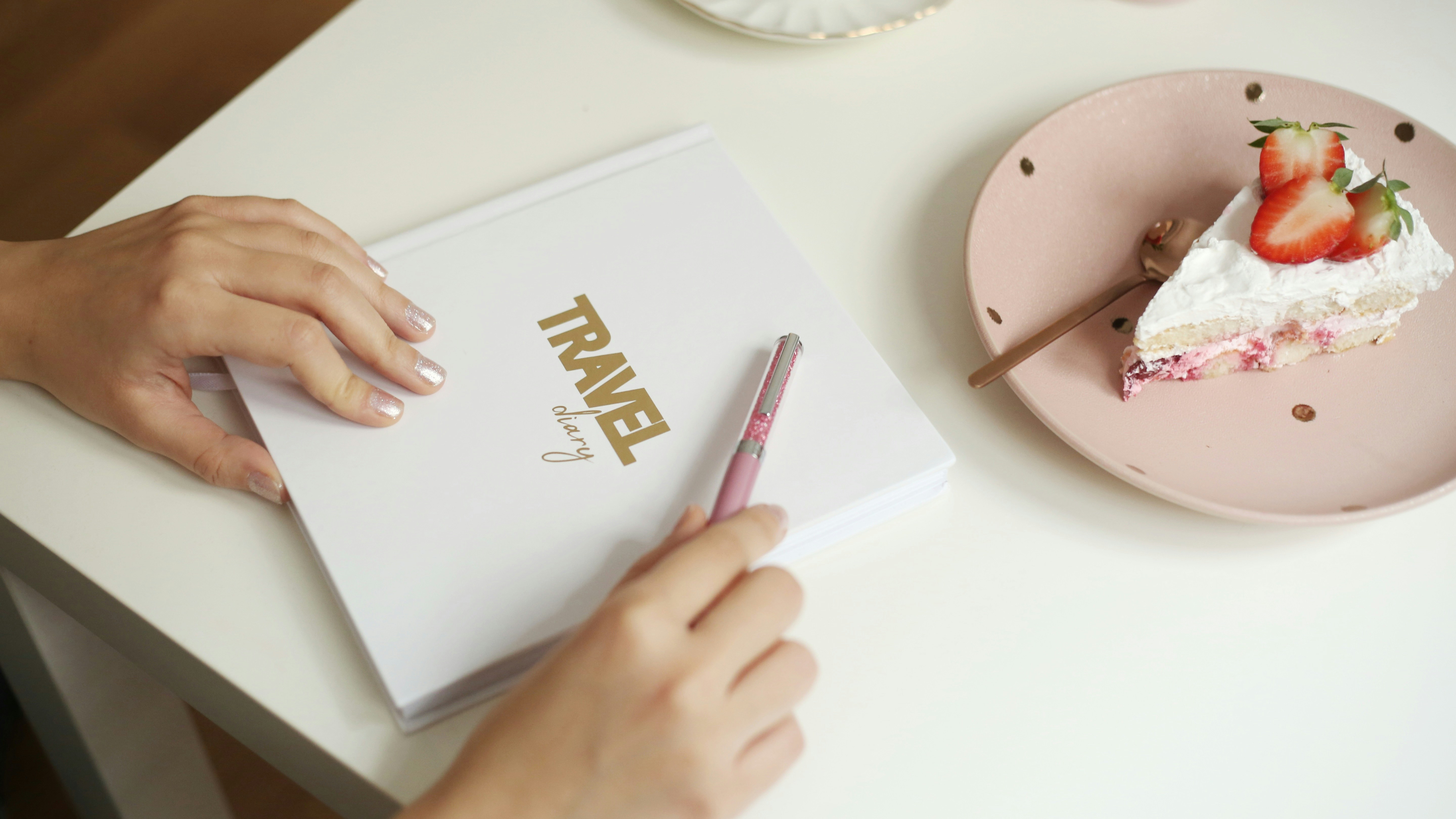 a person writing on a piece of paper