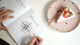 a person writing on a piece of paper