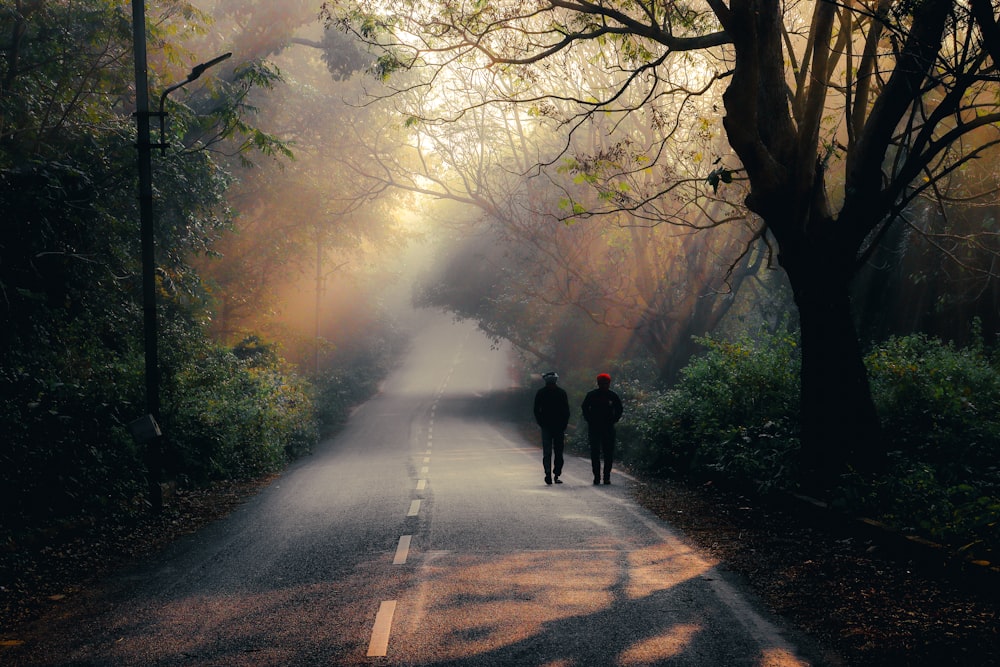 two people walking on a road