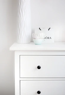 Minimalist dresser with neatly folded linens and tasteful décor accents.