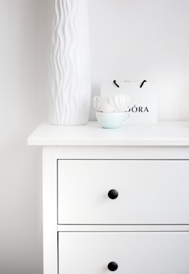 Minimalist dressing table with a sleek wooden top and subtle drawer handles.
