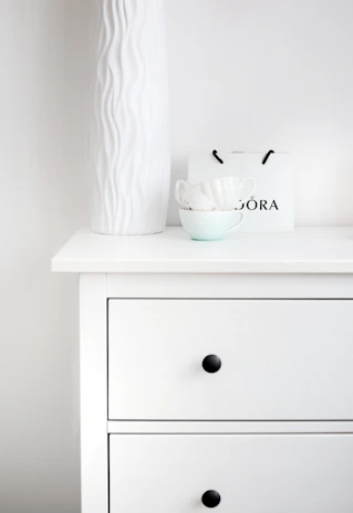 Minimalist dresser with neatly folded linens and tasteful décor accents.