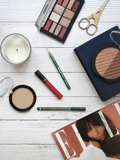 Elegant flat lay of shimmering eyeshadow palettes with pink and rose gold hues