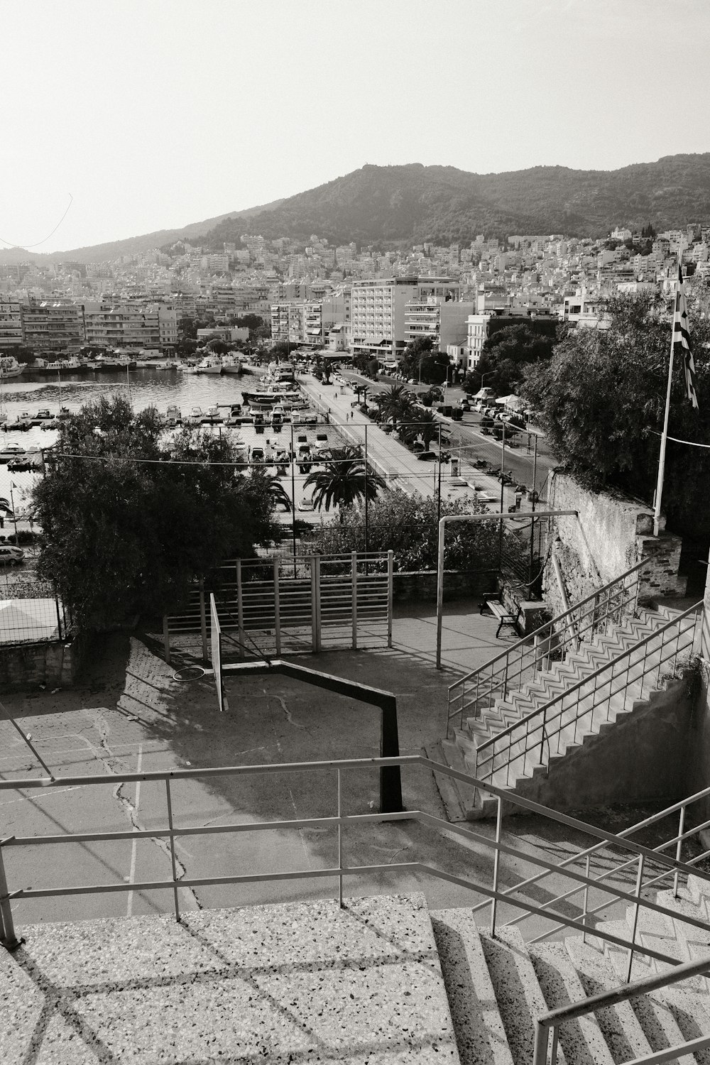 a large courtyard with a pool and buildings in the background