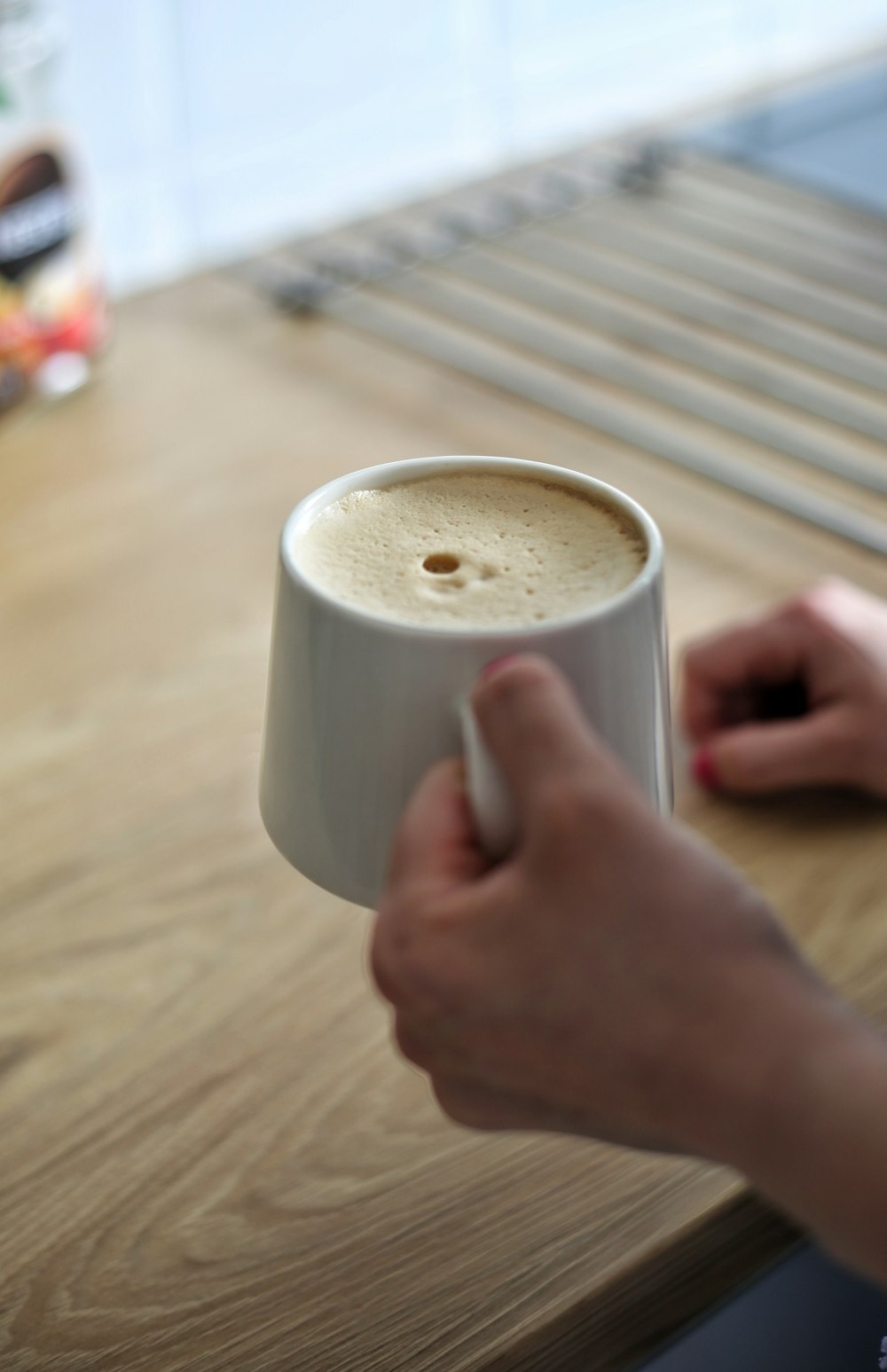 a hand holding a cup of coffee