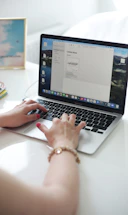 a person typing on a laptop