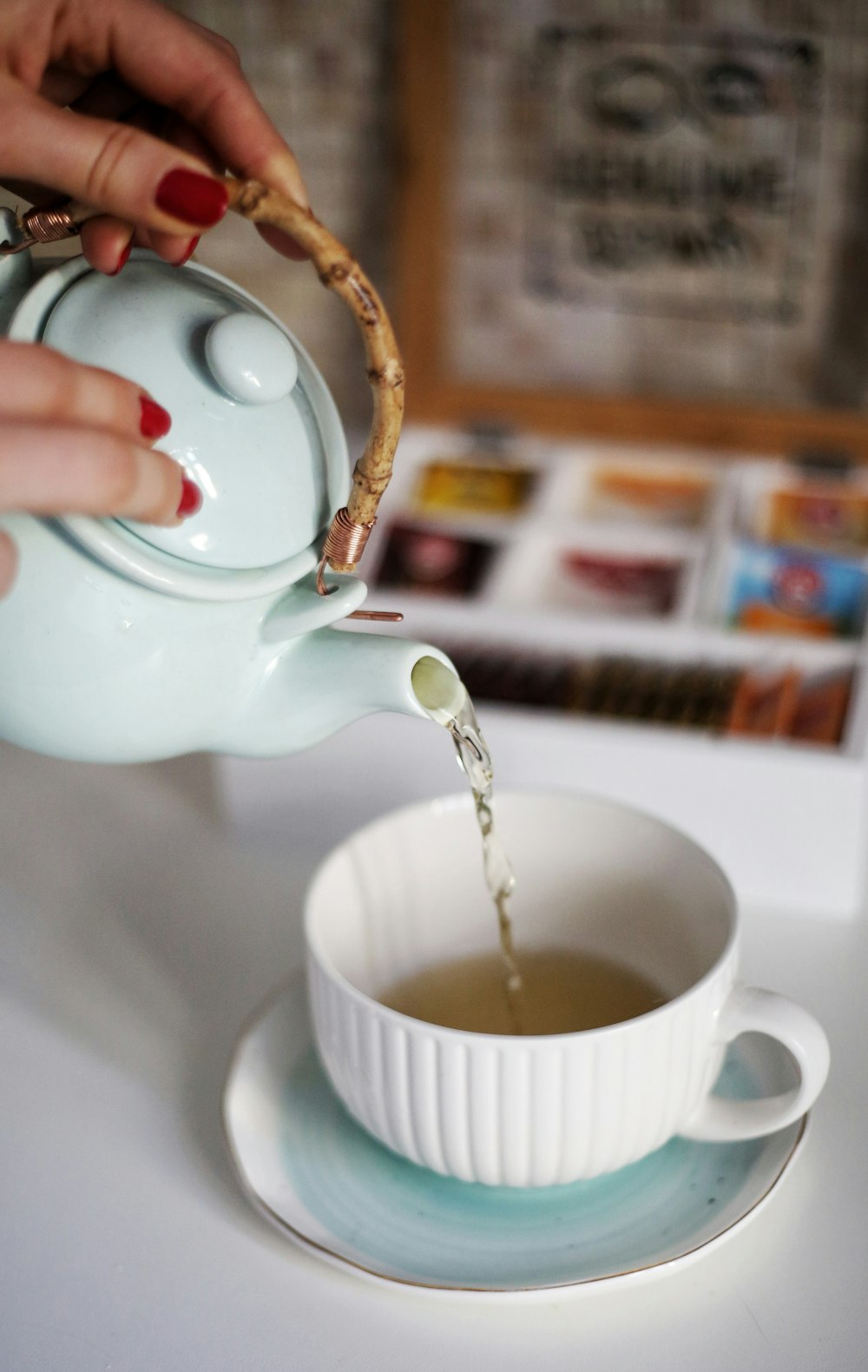 a person pouring a liquid into a cup