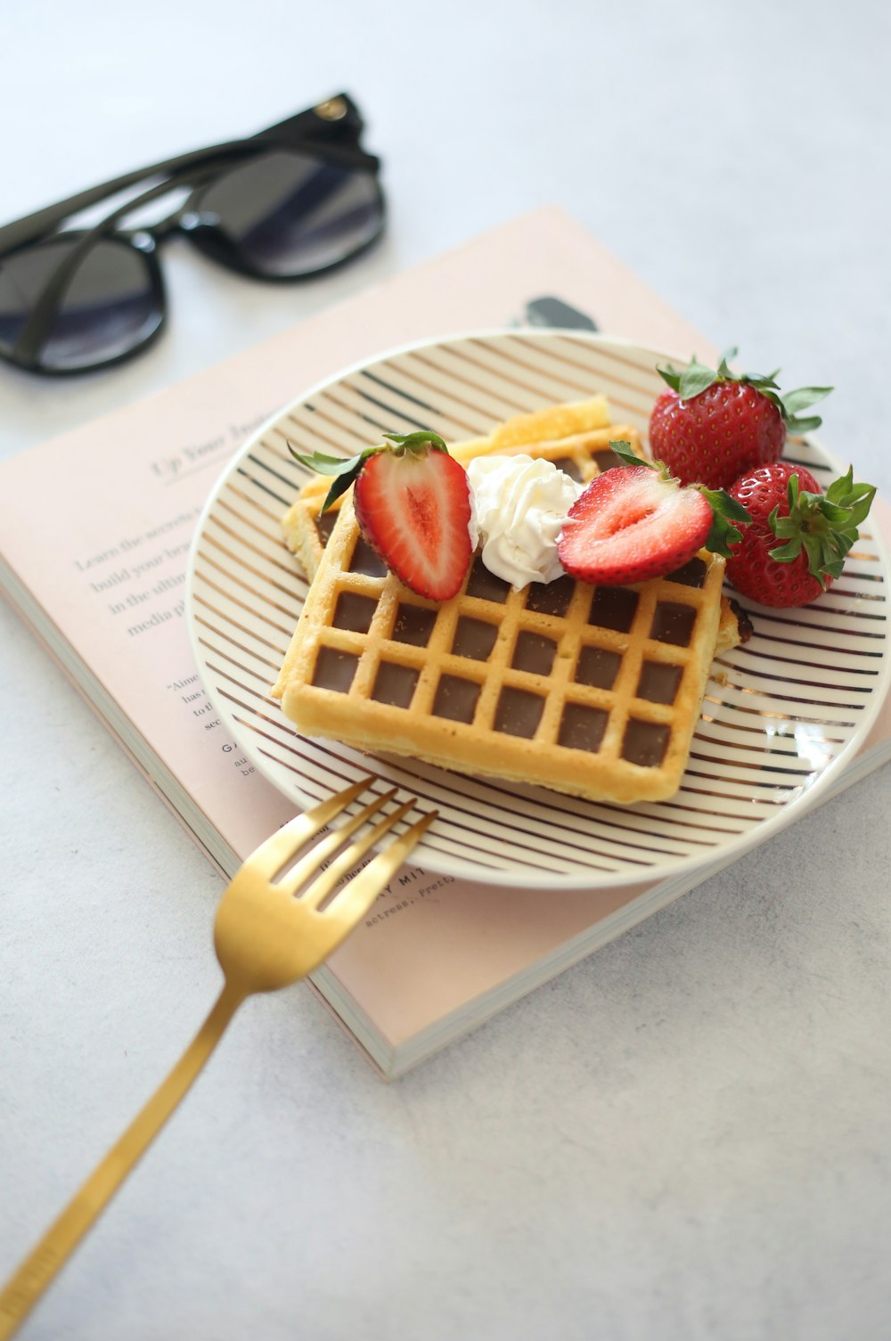 a waffle with strawberries and chocolate on top