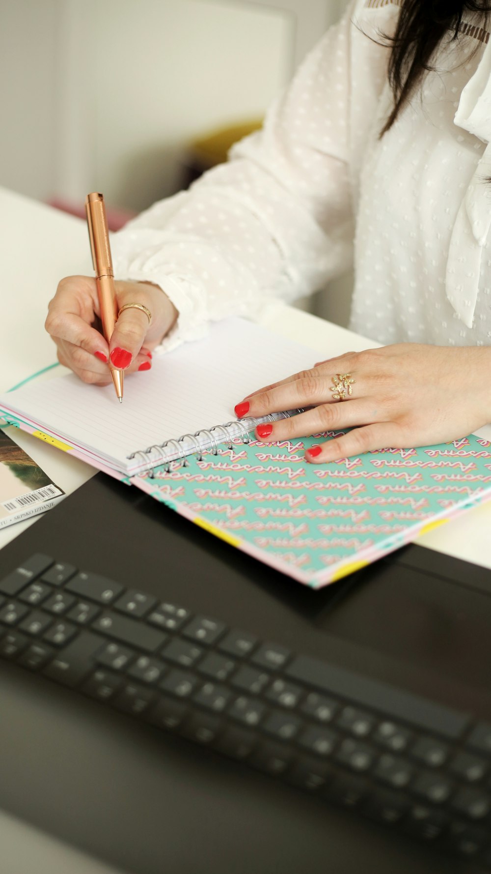 a person writing on a piece of paper