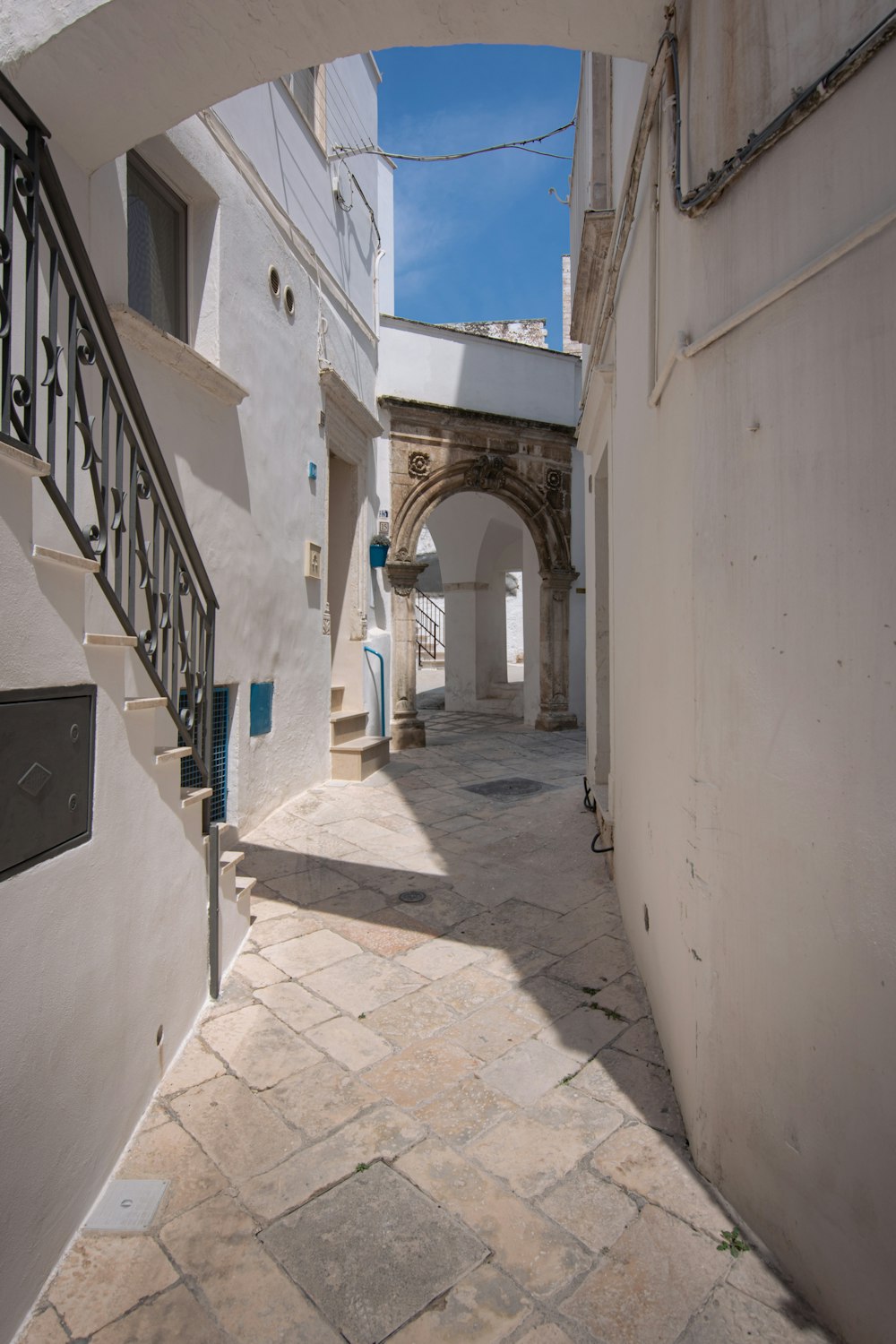a stone walkway between two buildings
