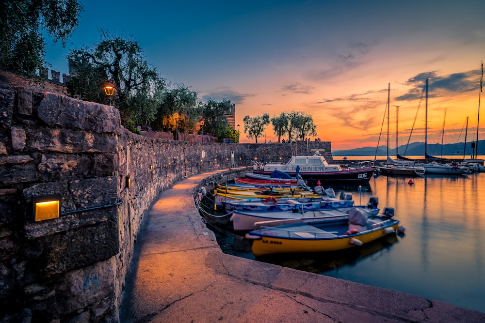 a row of boats parked on the side of a river