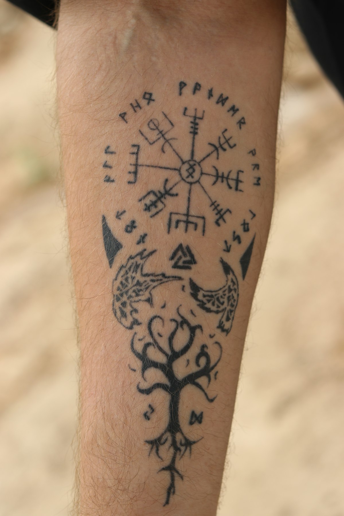 Tattooed arm resting on a studio armrest