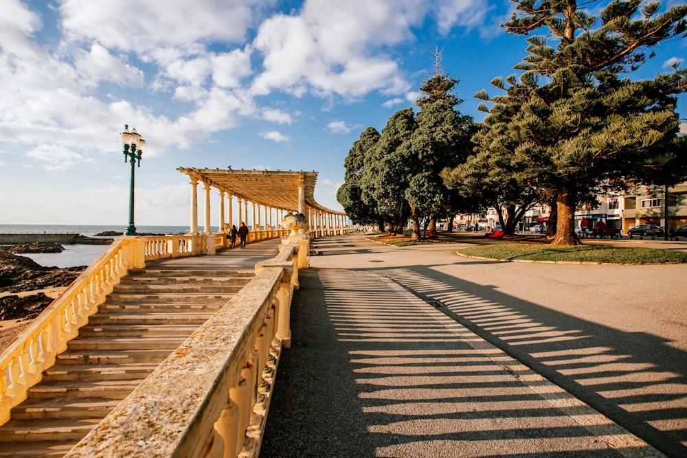 a wooden walkway with a stone walkway