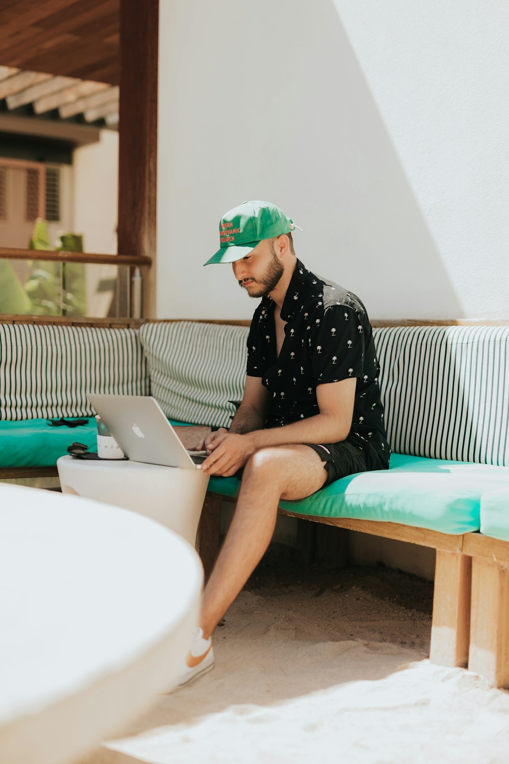 a person sitting on a couch using a laptop