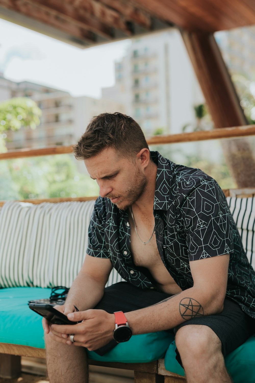 a person sitting on a bench looking at the phone